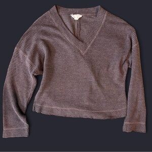 Women’s Small V-Neck Waffle Knit Sweater with a fringed design on the ends.